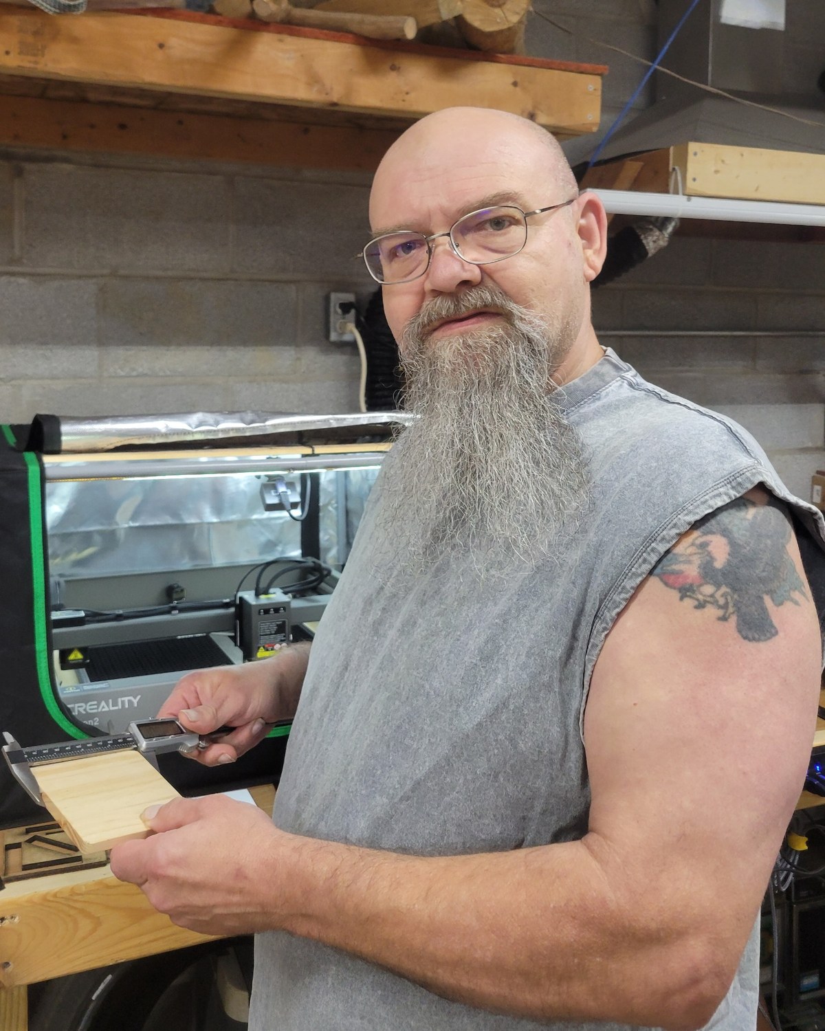 Wood U Laugh owner working in the shop with measuring tools and laser equipment